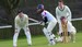 4 people playing community cricket in full uniform
